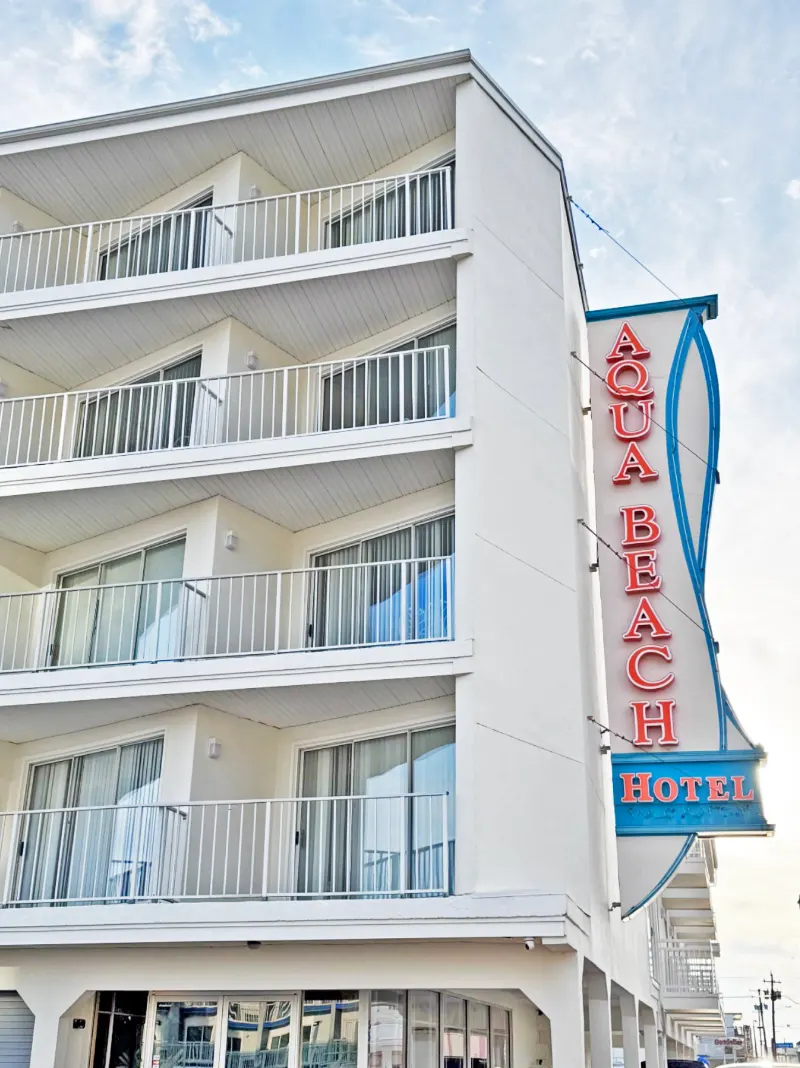 The Aqua Beach Hotel building with its vertical neon sign
