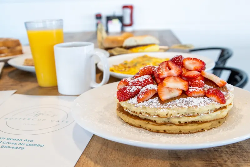 Strawberry pancakes with coffee and orange juice
