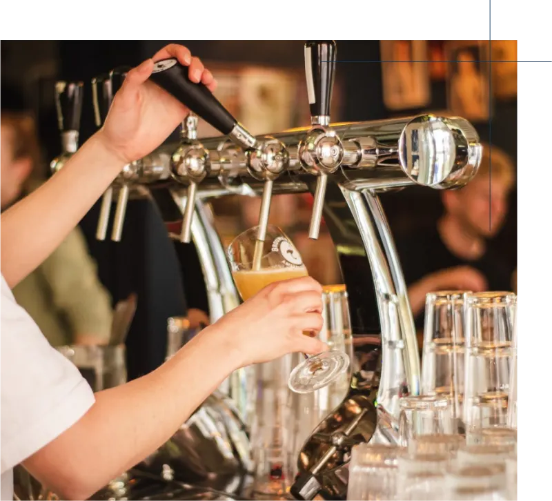 Bartender pouring a craft beer from a tap