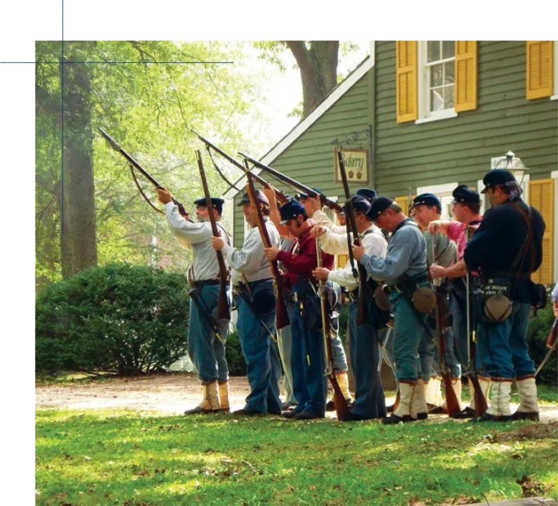 Historical reenactors in period uniform at Historic Cold Spring Village