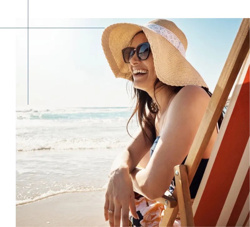Woman in a sun hat relaxing in a beach chair